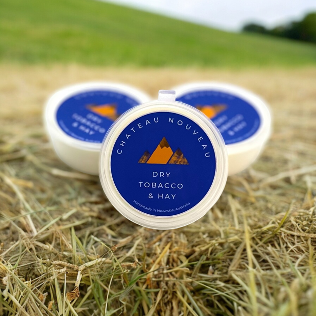 a couple of containers sitting on top of a grass covered field